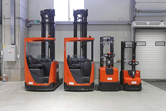 industrial forklifts loading cargo onto trucks